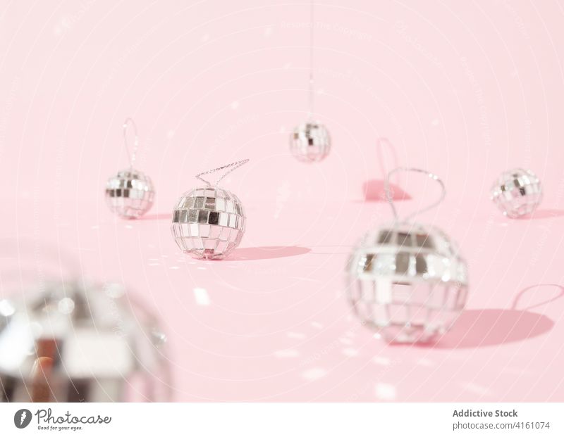 Shiny Christmas decorations on pink table christmas ball disco studio bauble shiny sparkle bright merry party new year celebrate holiday festive glow december