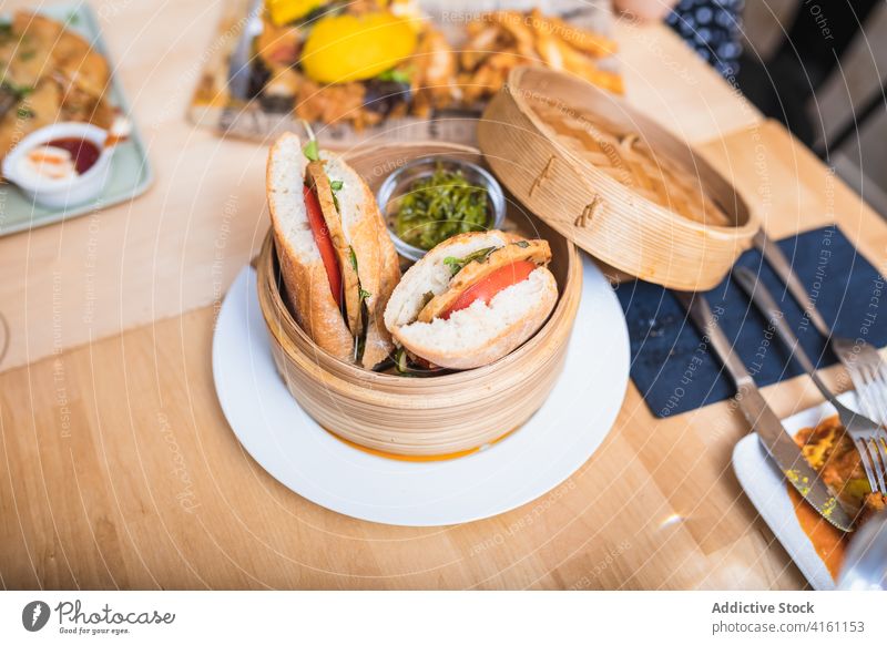 Table with delicious vegetarian sandwiches fast food lunch dinner menu meal restaurant naked bread cheese parsley hamburger tasty vegan appetizing wooden bowl