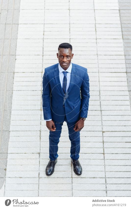 Black businessman in formal suit standing in city confident urban modern elegant executive success manager professional adult male entrepreneur african american