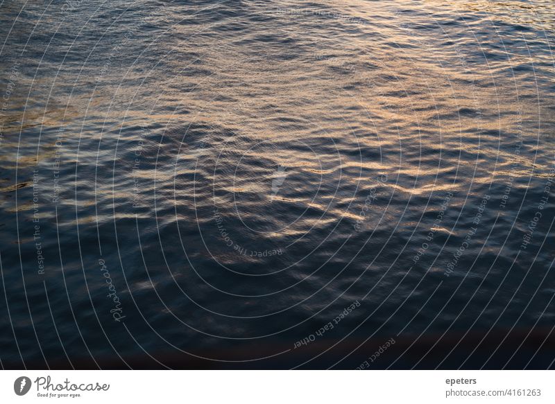 Dark, calm water surface during sunset Water Surface Surface of water Calm Sunset Waves Ocean Blue Deserted Sunlight Exterior shot Nature Evening Sunrise