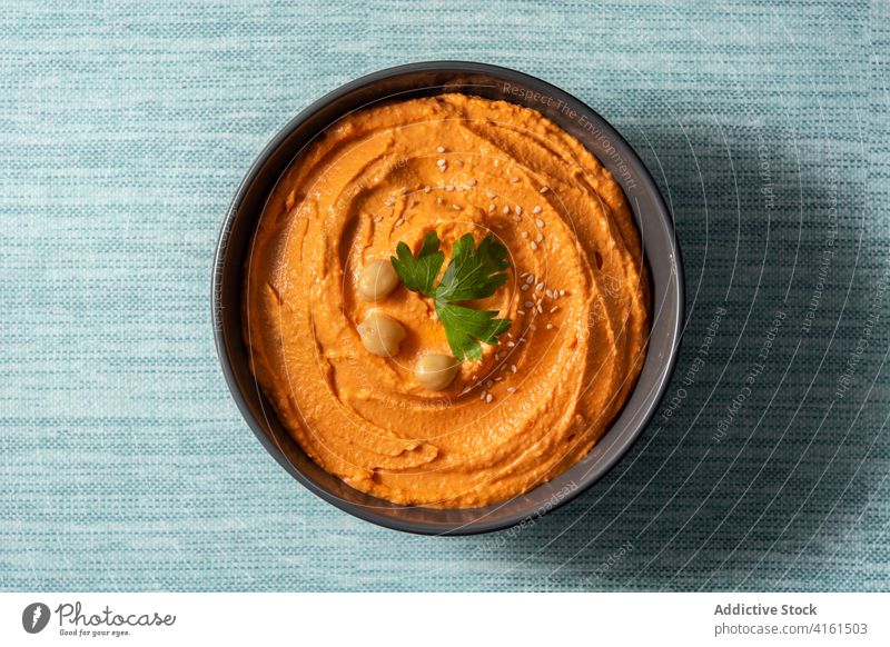 Pumpkin hummus in bowl arabic autumn blue bread chickpea coriander cream diet dip east food fresh greek halloween isolated lebanese lemon mediterranean