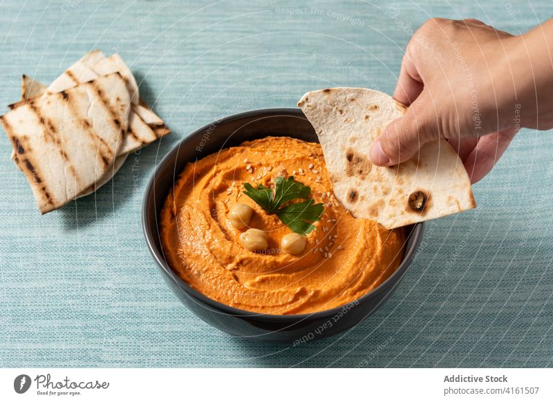 Pumpkin hummus in bowl arabic autumn blue bread chickpea coriander cream diet dip east food fresh greek halloween isolated lebanese lemon mediterranean