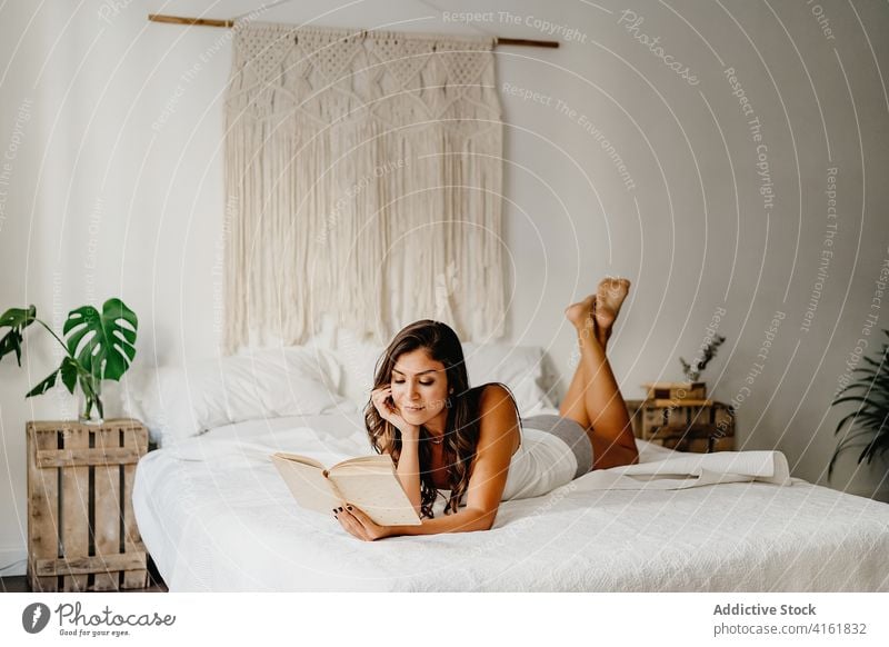 Woman reading book in bedroom woman home morning relax rest comfort chill cozy positive inspiration lean young female smile literature hobby pleasure leisure