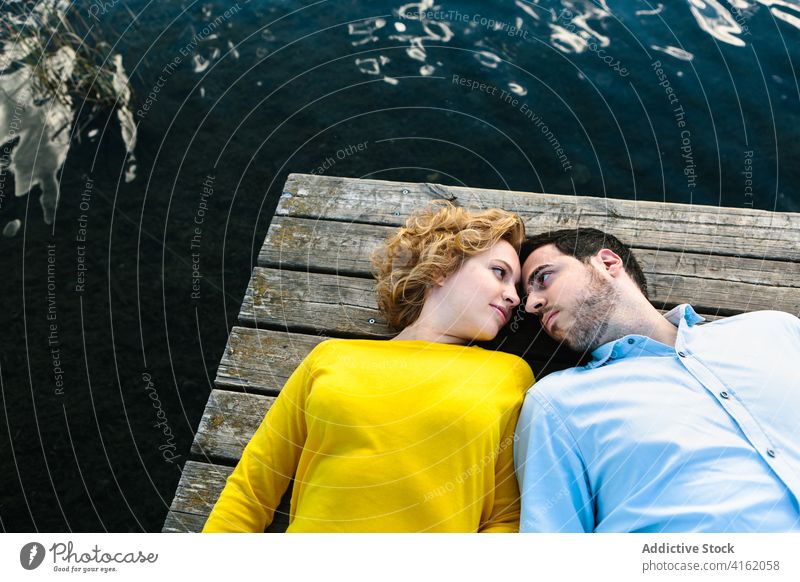 Couple in love relaxing on pier couple tender quay lake summer rest relationship gentle lying wooden romantic boyfriend water together date nature enjoy