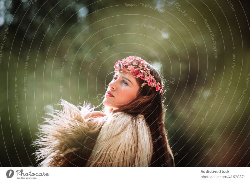 Tender young woman in flower wreath standing in forest romantic nature portrait tender charming sensual beautiful female floral style natural gentle fresh tree