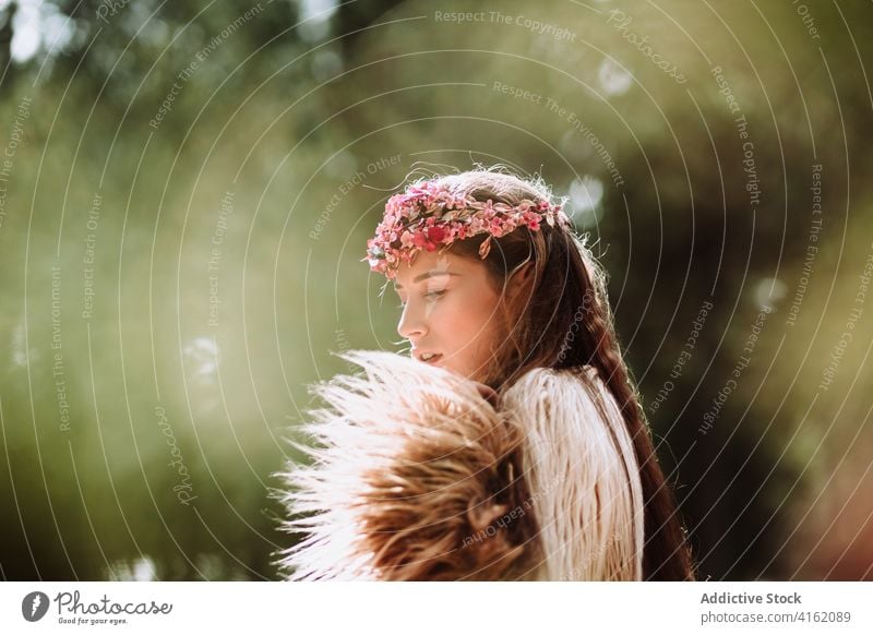 Tender young woman in flower wreath standing in forest romantic nature portrait tender charming sensual beautiful female floral style natural gentle fresh tree