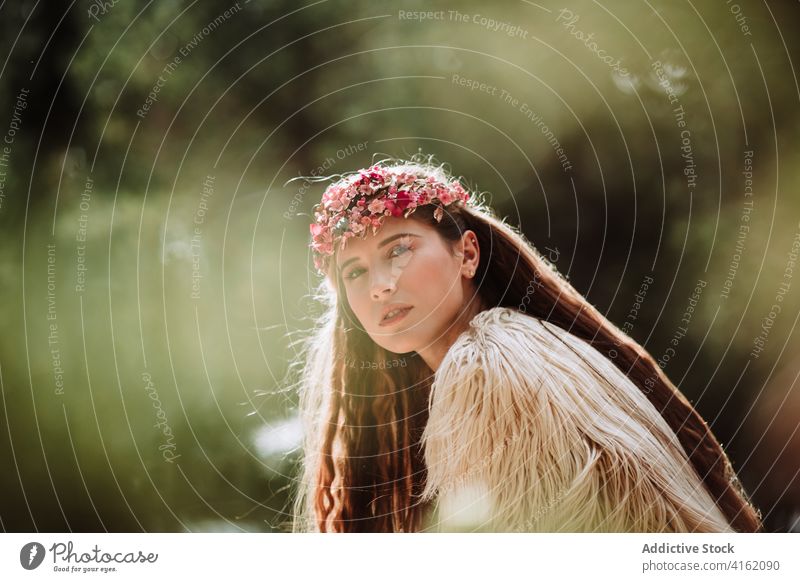 Tender young woman in flower wreath standing in forest romantic nature portrait tender charming sensual beautiful female floral style natural gentle fresh tree