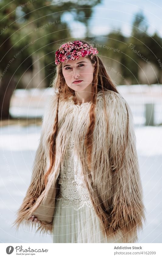 Nordic bride in fur wear standing on snowy meadow woman fashion nordic wedding style nature forest wreath season blond winter spring young female jacket floral