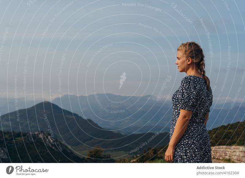 Serene woman admiring vast mountainous landscape on foggy day highland admire serene travel scenery hillside nature picturesque environment peaceful mist