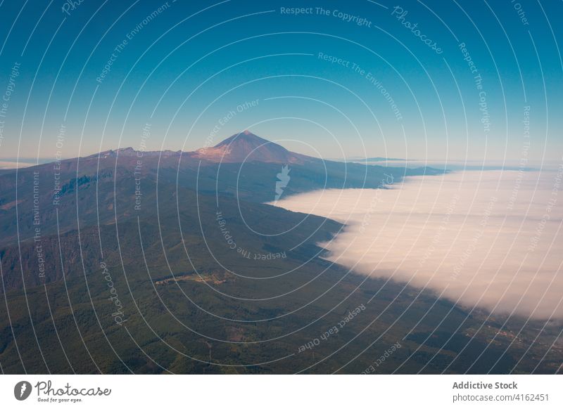 Airplane flying over mountains in morning airplane flight landscape amazing scenic scenery highland aircraft tenerife canary islands spain detail travel