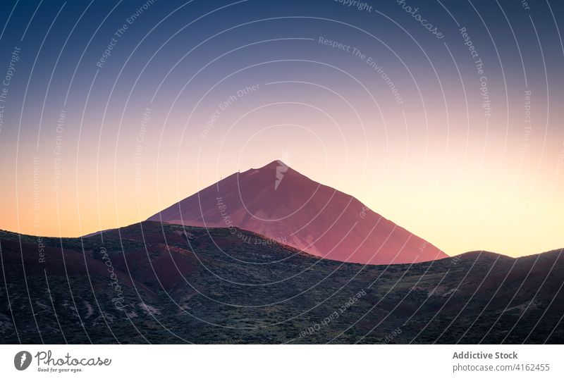 Peaceful sunrise over Teide mountain valley in summer morning highland dawn illuminate orange vivid plant canary islands spain tenerife lush terrain picturesque