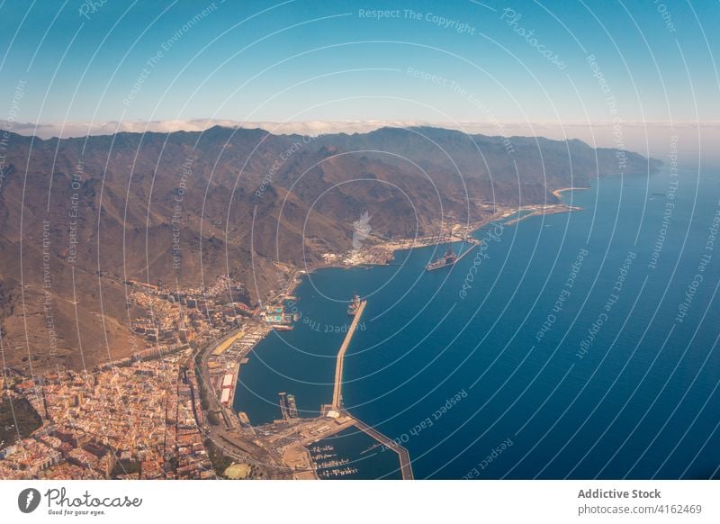 Airplane flying over the coastal port in morning airplane flight landscape mountain amazing highland aircraft tenerife canary islands spain detail travel