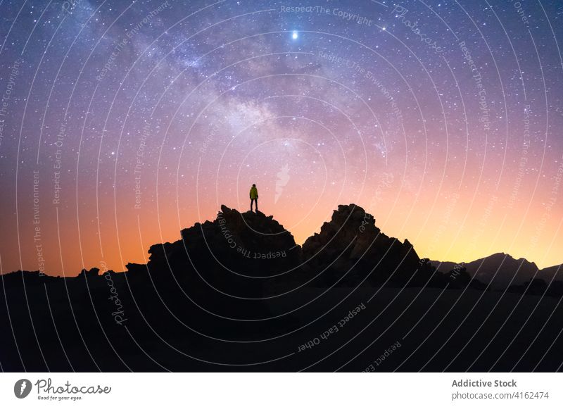 Traveling man on hill at night sky starry traveler together silhouette galaxy milky way admire canary islands tenerife spain rock dark atmosphere astronomy