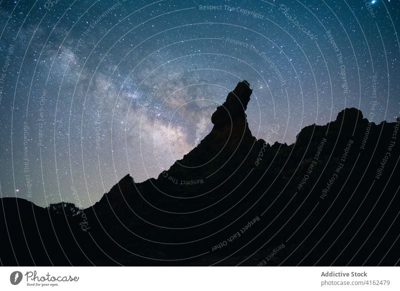 Starry sky over mountainous terrain at night milky way star starry hill rock silhouette dark canary islands spain tenerife breathtaking landscape rocky universe