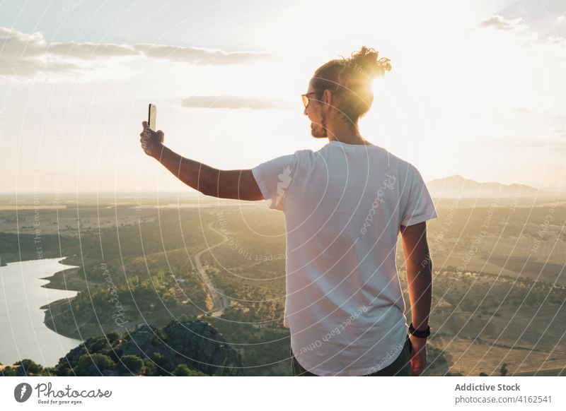 Unrecognizable person standing on hilltop and taking photos of valley take photo photographer smartphone nature wanderlust travel amazing traveler device