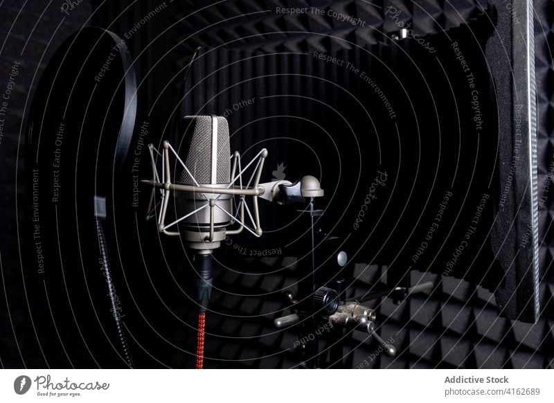 Modern microphone in dark studio record music soundproof foam equipment modern audio professional gadget song melody electronic device metal wire broadcast