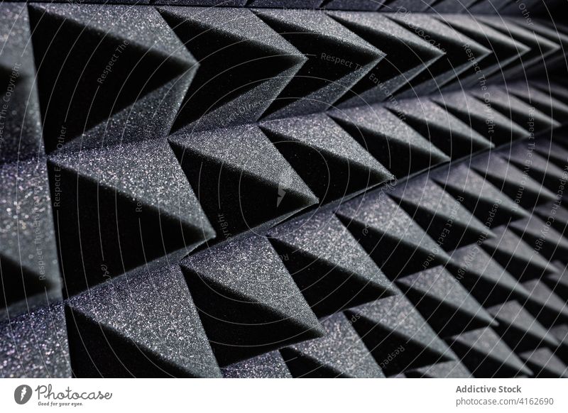 Textured background of soundproof foam pattern texture geometry three dimensional shape soft record studio wall pyramid black structure surface design material