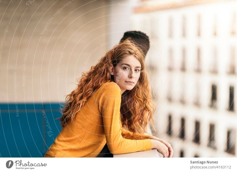 Redhead Woman Portrait looking at camera standing front view portrait relationship multi-racial black man caucasian multi-cultural multi-ethnic together