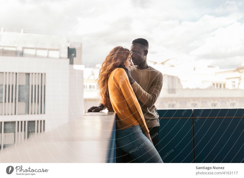 Loving Multiethnic Couple looking at each other kissing portrait front view standing relationship multi-racial black man caucasian multi-cultural multi-ethnic