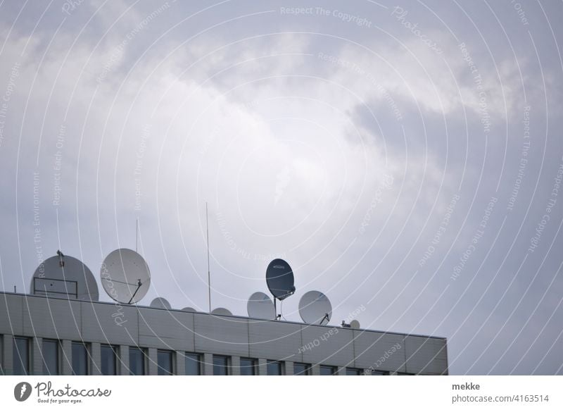 Satellite dishes decorate the modern roof terrace House (Residential Structure) Roof Antenna Town Facade Sky Building Clouds Satellite Dish Radio Television