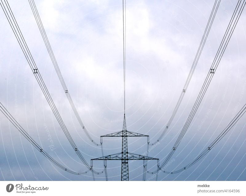 Symmetrical power lines against cloudy sky Electricity pylon stream Transmission lines Energy industry Cable Sky High voltage power line Power transmission