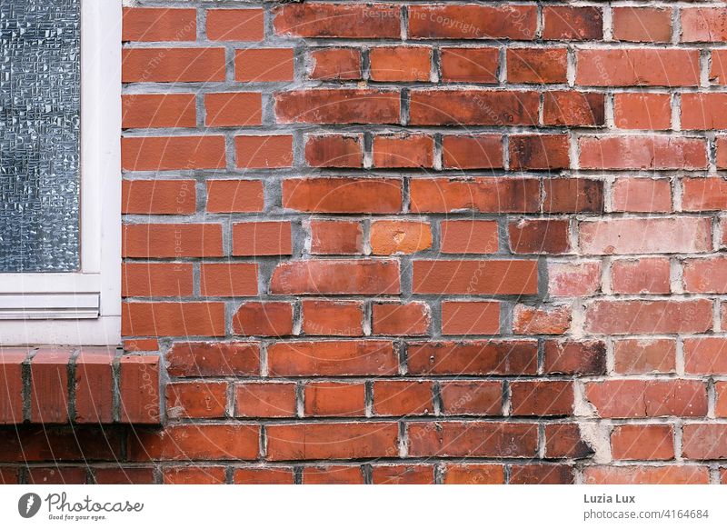 Part of a brick wall with cut window sill and window. The differently coloured bricks form a mysterious pattern. Architecture Stone Red Detail Day Pattern Old