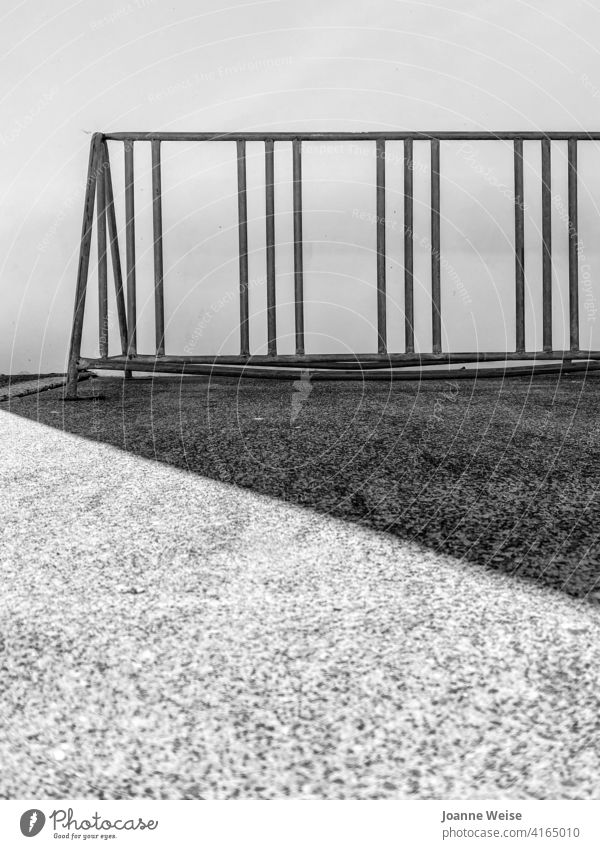 Metal bicycle rack with shadows. Black & white photo Bicycle rack Exterior shot Deserted Gritty Afternoon sun Day Cycling Transport Copy Space bottom Old