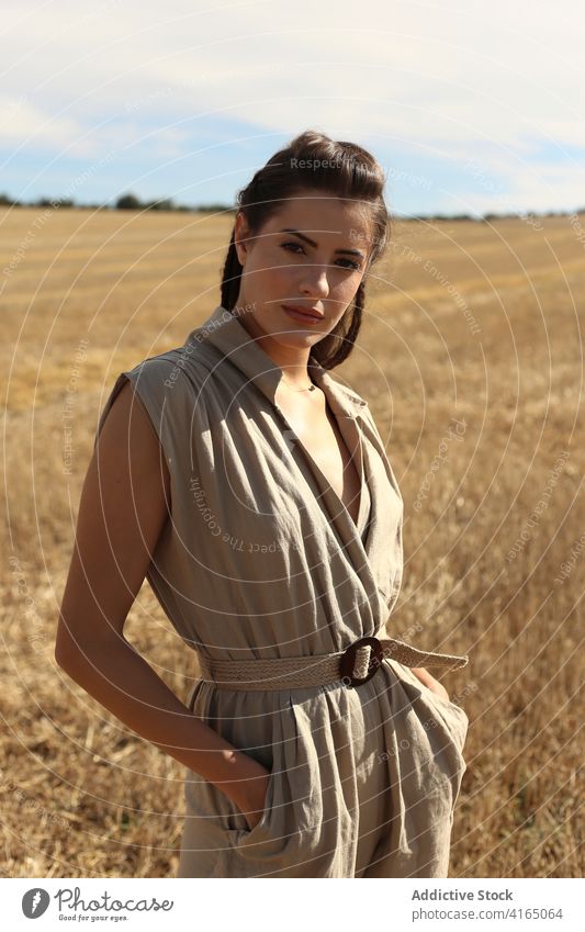 Gorgeous woman standing on field in countryside walk style gorgeous grace trendy elegant stroll environment picturesque fashion attractive posh serene scenery