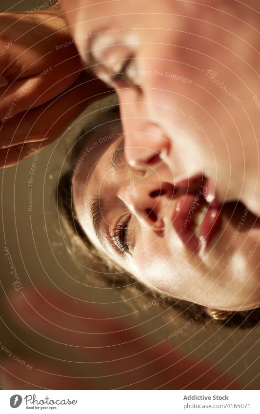 Thoughtful young woman leaning chin and hand at mirrored table sensual thoughtful pensive reflection style calm ponder appearance personality female human face