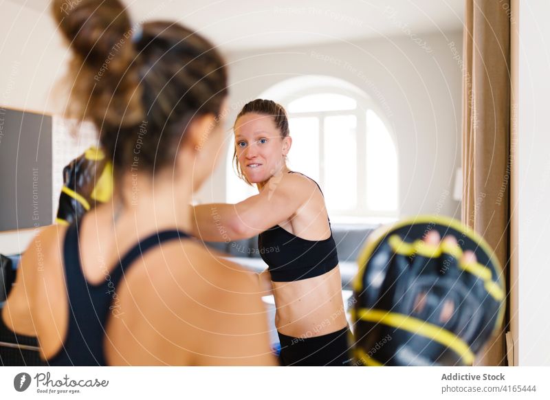 Sportswomen preparing for boxing training at home sportswomen prepare glove mitt mitten equipment personal instructor coach fighter exercise healthy sportswear