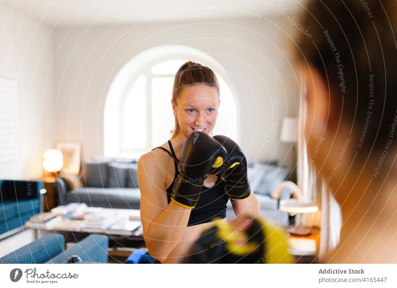 Sportswomen preparing for boxing training at home sportswomen prepare glove mitt mitten equipment personal instructor coach fighter exercise healthy sportswear