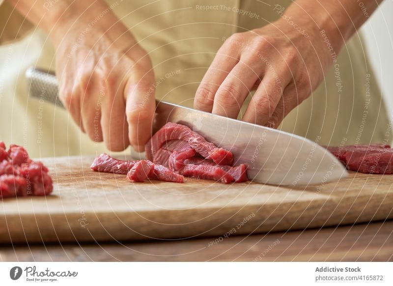 Crop woman cutting meat in kitchen beef cook steak tartare housewife prepare dinner dish cutting board chopping board fresh wooden delicious cuisine knife