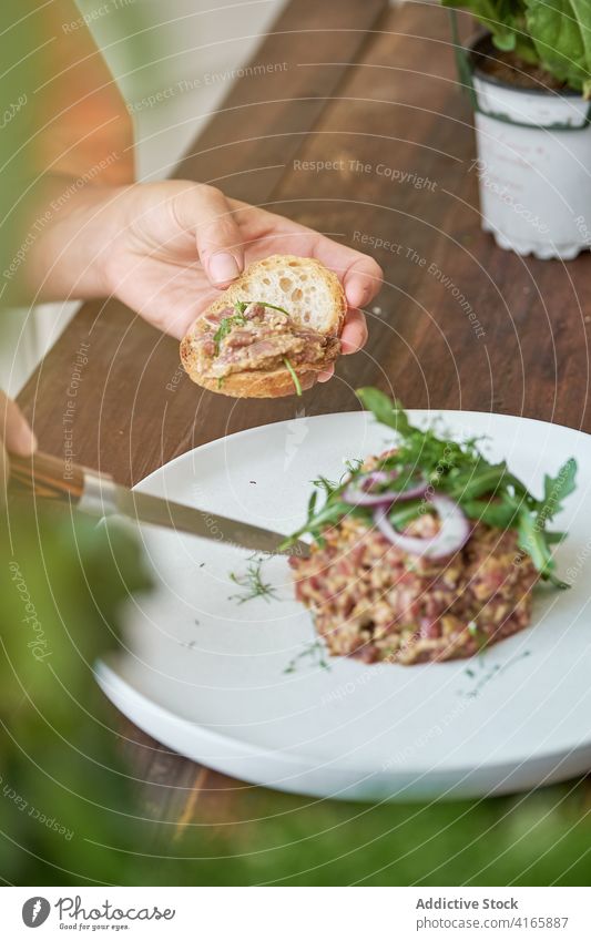 Pensive woman having tasty lunch at home steak tartare eat enjoy dish delight sitting female plate table happy gourmet healthy nutrition relax lady pleasure