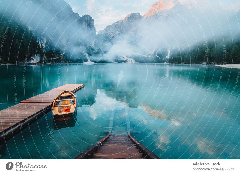 Wooden pier near lake turquoise mountain travel wanderlust landscape water amazing traveler wooden quay scenery holiday pond shore nature breathtaking majestic