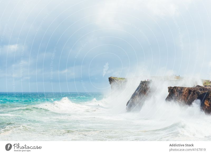 Stormy sea near rocky cliff stormy foam wave seascape power water roll scenery spectacular rough picturesque landscape majestic splash sunny stone nature scenic