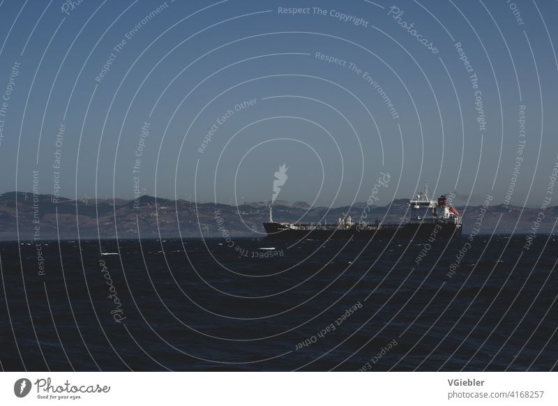 Ship off the coast of Africa / Morocco in the Strait of Gibraltar / Container ship Navigation Ocean Waves Industry Water Deserted Landscape Exterior shot Blue