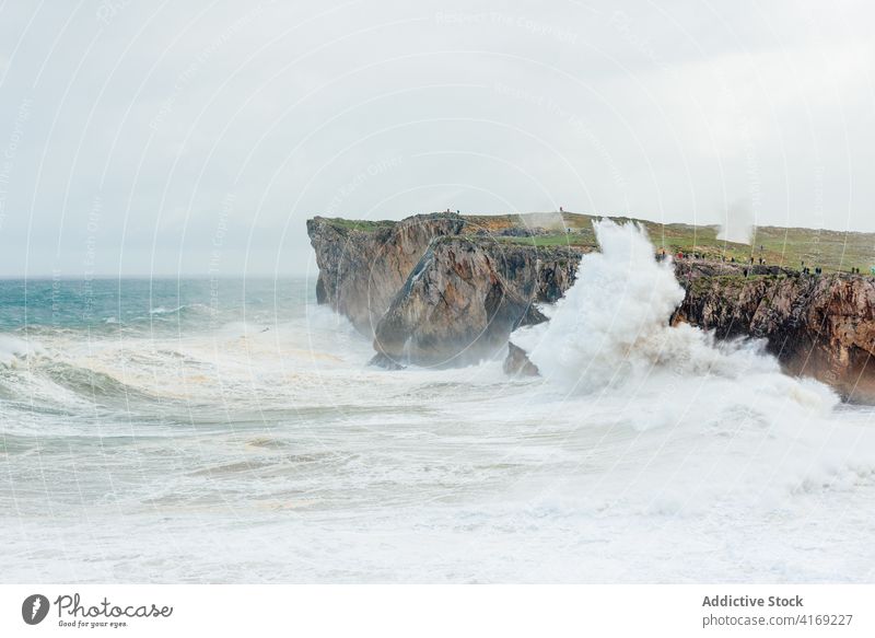 Stormy sea near rocky cliff stormy foam wave seascape power water roll scenery spectacular rough picturesque landscape majestic splash sunny stone nature scenic