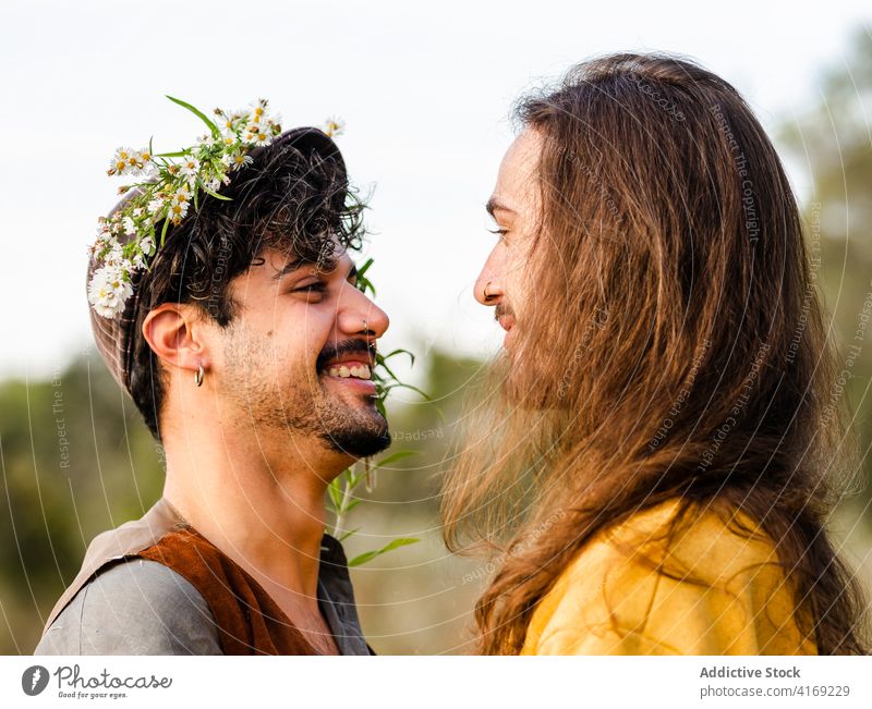 Happy gay couple in nature homosexual men love embrace passion intimate romantic relationship lgbt young happy ethnic male together affection tender boyfriend