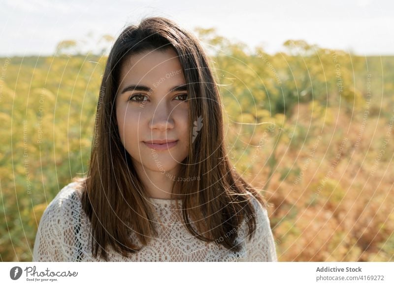 Charming woman in field in summer relax charming countryside chill tender smile meadow female rest calm serene grass idyllic casual peaceful happy nature