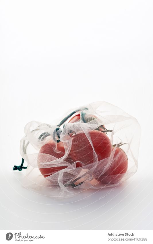 Vegetables in plastic bag food tomatoes ecology transparent white ingredient green waste texture light indoor studio meal vegan vegetarian healthy grocery