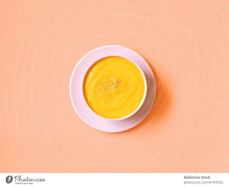 Pumpkin soup in bowl on pink table pumpkin cream minimal simple food vegetarian vegan healthy food appetizing delicious tasty yummy gourmet tradition meal fresh