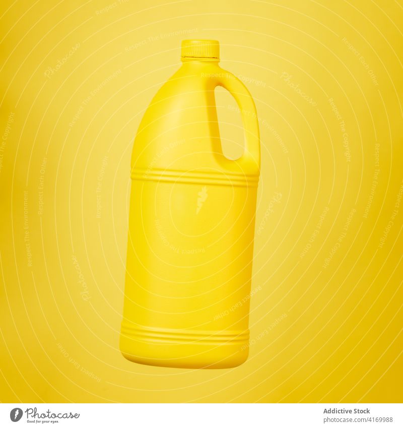 Plastic bottle from detergent on yellow background plastic cleanse hygiene container liquid product household housework studio vivid vibrant color bright