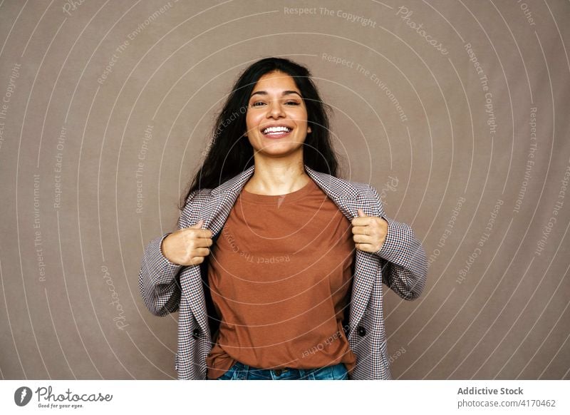 Cheerful woman in stylish wear in studio style jacket trendy laugh cheerful having fun model charming female ethnic happy young pleasure relax optimist modern