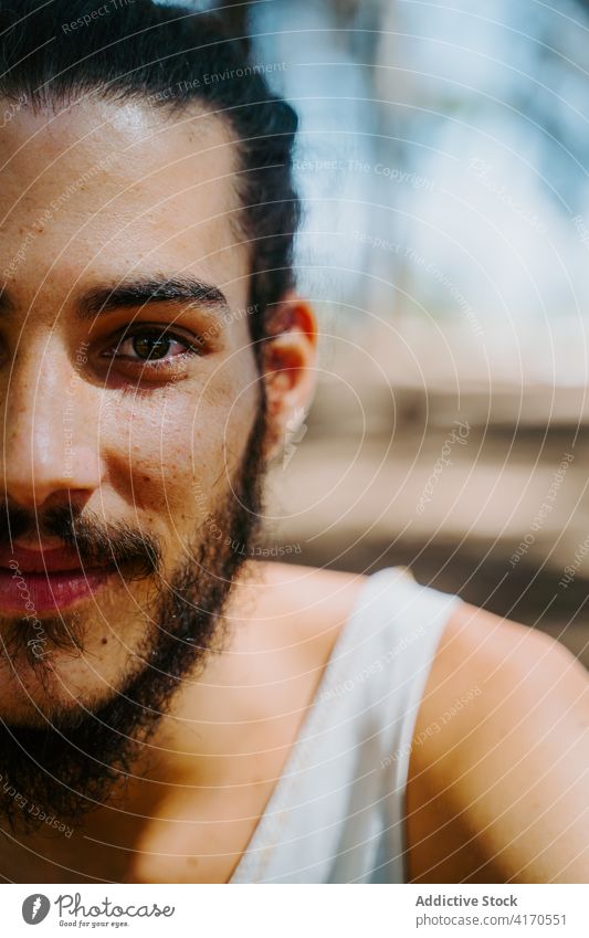 Smiling ethnic man looking at camera portrait smile beard appearance cheerful tender nature complexion summer male glad optimist pleasant harmony content