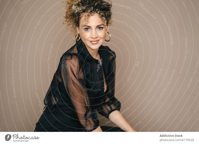 Positive woman smiling in studio having fun candid sincere positive style curly hair afro female hairstyle cheerful happy glad carefree relax joy delight