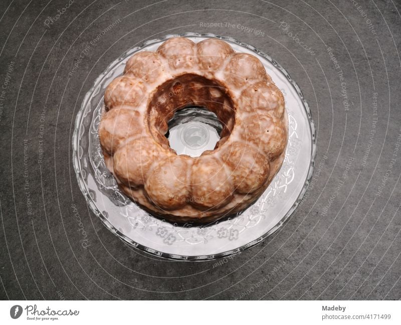 Round cake in a classic Gugelhupf cake tin on a grey concrete floor in a designer apartment in Rudersau near Rottenbuch in the district of Weilheim-Schongau in Upper Bavaria