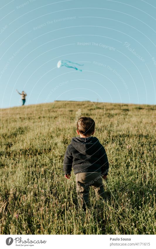 Rear view child looking at Kite Child 1 - 3 years Playing Boy (child) Infancy Human being Toddler Colour photo Joy Happiness Leisure and hobbies Nature Life