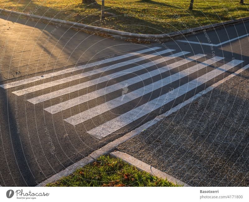 Zebra crossing over a bike path at sunset cycle path Bicycle nobody Deserted Transport Street Sunset Light Pedestrian Footpath Intersection Yield sign