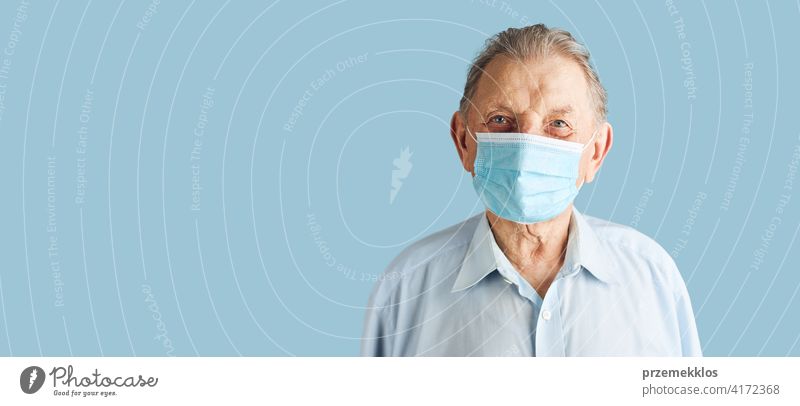 Old aged senior male patient with face mask protection against coronavirus covid-19 person disease health care hygiene copy space man alone clinic covid19