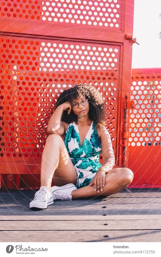 African woman sitting on the floor african female young girl afro black lifestyle portrait young adult looking relaxation fashion beauty pretty cheerful